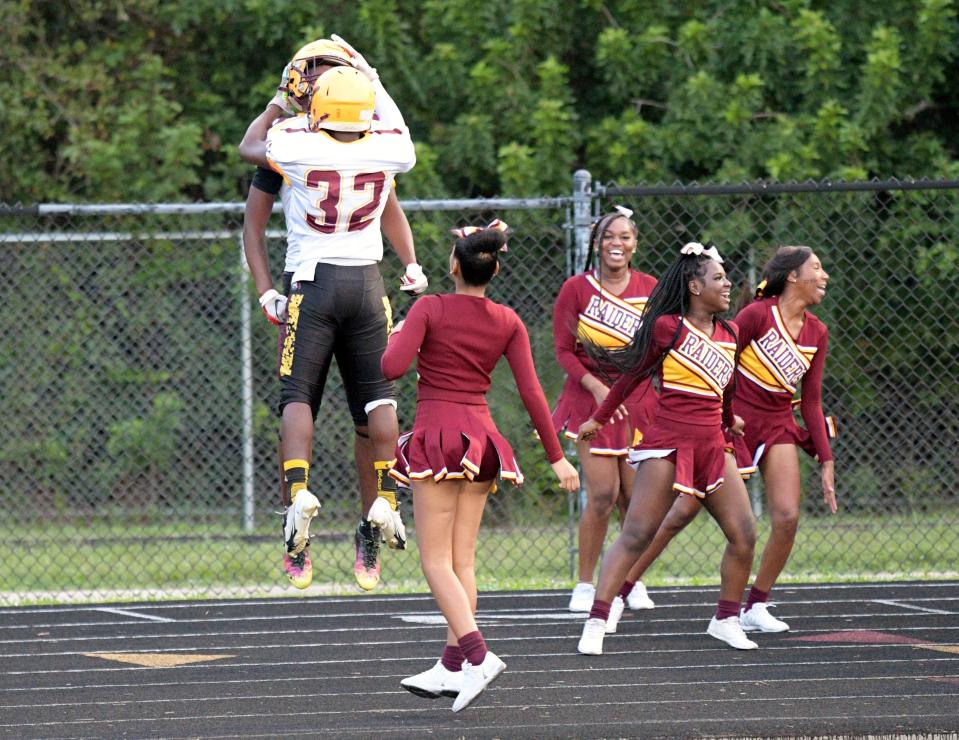 Glades Central receiver Robert Luckas celebrates with teammate Ar'Maud Stinfort following his touchdown reception in the second quarter of Friday's contest against Dwyer.