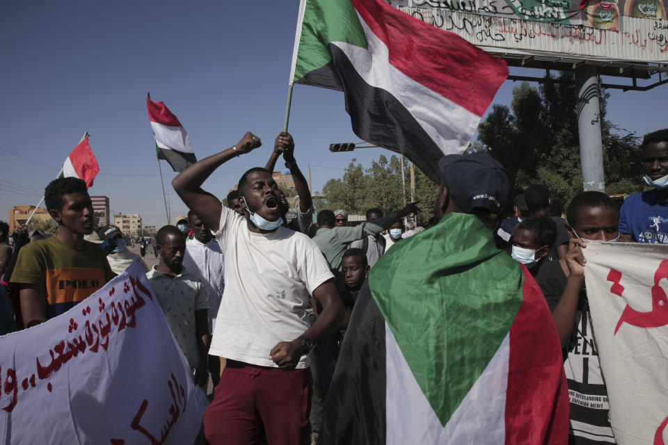 Thousands of protesters take to the streets to renew their demand for a civilian government in the Sudanese capital Khartoum, Thursday, Nov. 25, 2021. The rallies came just days after the military signed a power-sharing deal with the prime minister, after releasing him from house arrest and reinstating him as head of government. The deal came almost a month after the generals orchestrated a coup. Sudan’s key pro-democracy groups and political parties have dismissed the deal as falling short of their demands for a fully civilian rule. (AP Photo/Marwan Ali)