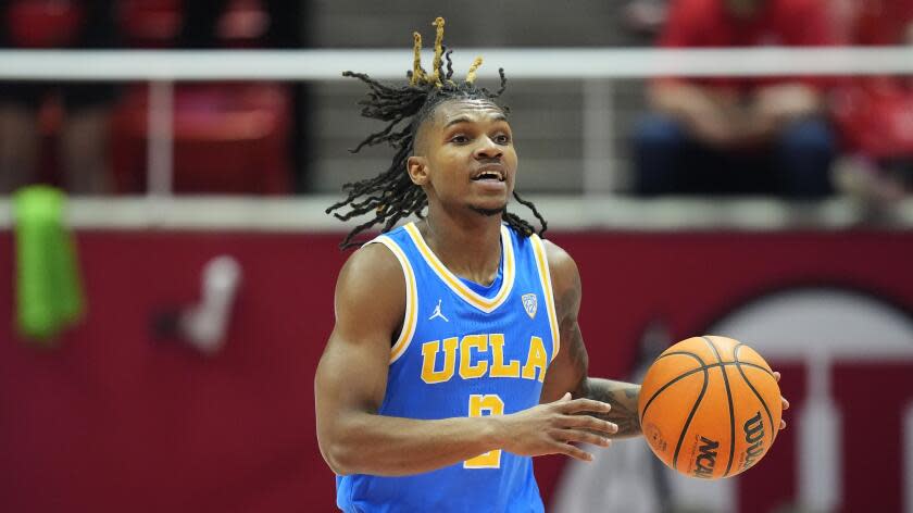 UCLA guard Dylan Andrews (2) brings the ball up court during the first half of an NCAA college basketball game against Utah Thursday, Jan. 11, 2024, in Salt Lake City. (AP Photo/Rick Bowmer)