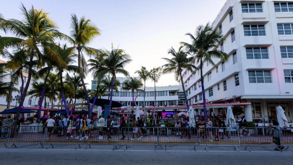 People walk past The Clevelander Bar and Hotel during Memorial Day weekend at Miami Beach, Florida, on Sunday, May 28, 2023.