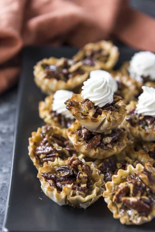 <p>The Crumby Kitchen</p><p>These adorable little two-bite mini pecan pies are made with no corn syrup and are baked up in crispy phyllo shells in about 30 minutes, making them a fabulous last-minute low-sugar holiday treat!</p><p><strong>Get the recipe: <a href="https://thecrumbykitchen.com/mini-pecan-pie-tarts/" rel="nofollow noopener" target="_blank" data-ylk="slk:Mini Pecan Pie Tarts;elm:context_link;itc:0;sec:content-canvas" class="link ">Mini Pecan Pie Tarts</a></strong></p>