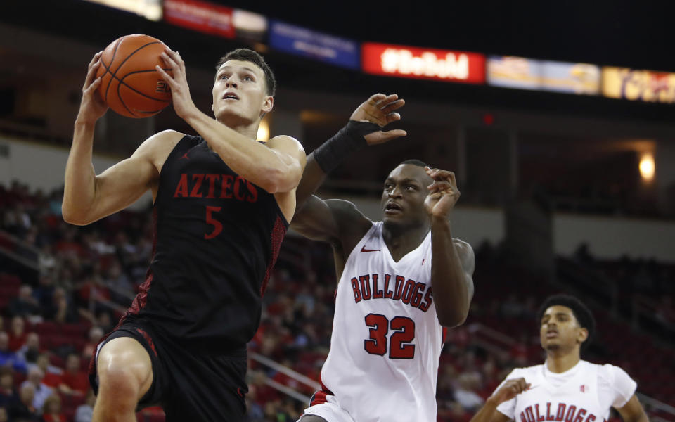 San Diego State's Yanni Wetzell drives past Fresno State's Nate Grimes during the second half of an NCAA college basketball game in Fresno, Calif., Tuesday Jan. 14, 2020. (AP Photo/Gary Kazanjian)