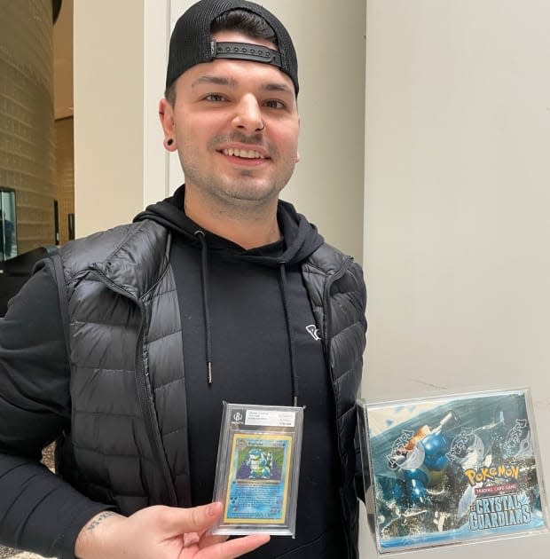Daniel Daoust holds his prized Pokémon possession, a First Edition Shadowless Blastoise, which can be worth thousands of dollars, depending on the condition.
