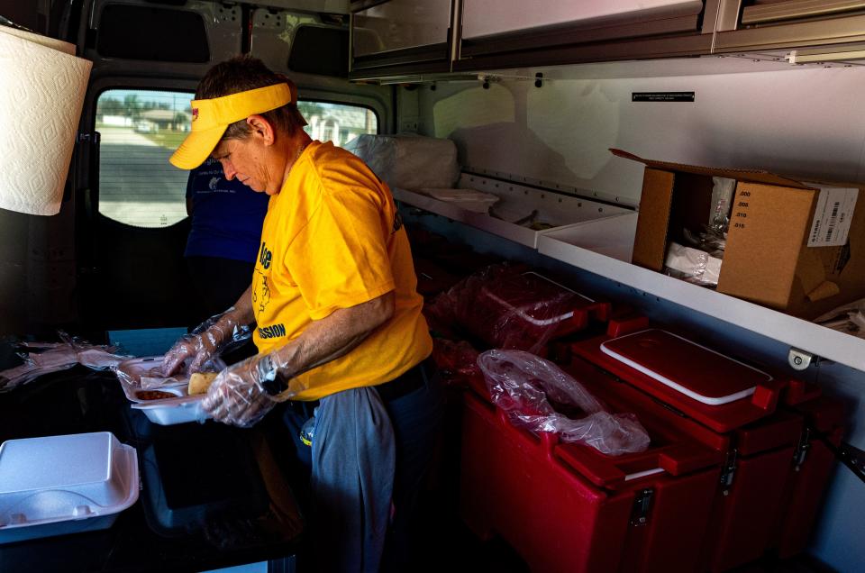 Kay Hayden, a resident of Fort Myers, helps deliver meals alongside the Red Cross in Cape Coral following Hurricane Ian on Oct. 3, 2022. 