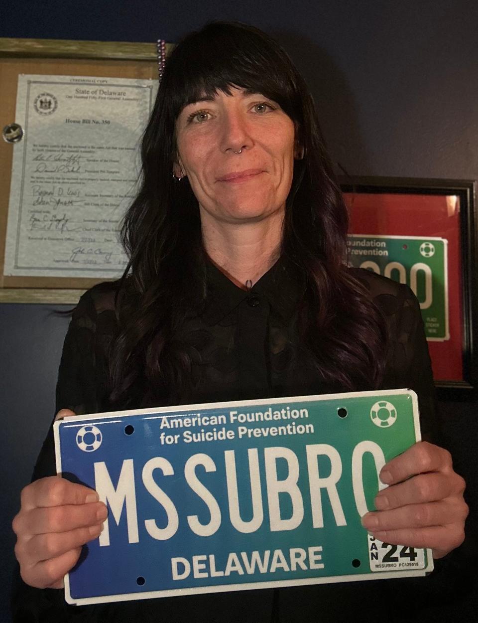 Delaware resident Jennifer Staley with her custom American Foundation for Suicide Prevention license plate in memory of her brother-in-law who died by suicide in November 2020.
