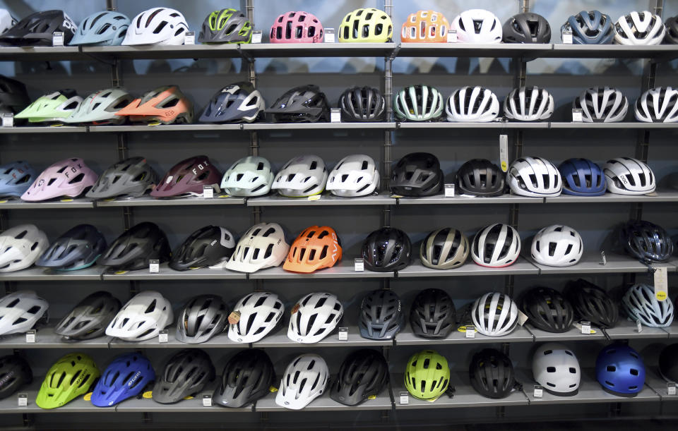 Helmets are displayed at University Bicycles in Boulder, Colo., Tuesday, April 30, 2024. Bike stores quickly sold out of their stock early in the pandemic and had trouble restocking because of supply chain issues. Now, inventory is back, but demand has waned. (AP Photo/Thomas Peipert)