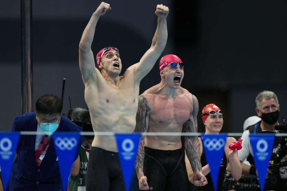 James Guy, of Britain, and teammate Adam Peaty celebrate winning the gold medal in the mixed 4x100-meter medley relay final at the 2020 Summer Olympics, Saturday, July 31, 2021, in Tokyo, Japan. (AP Photo/Jae C. Hong)