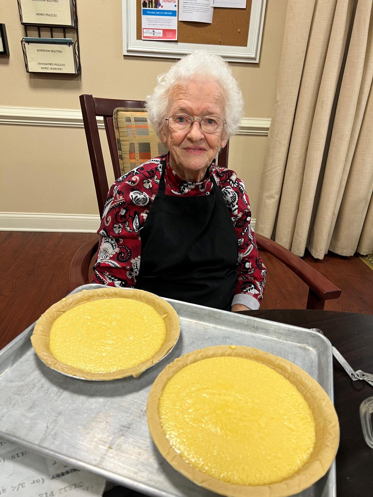Cleo Wayman proudly admires her pie that won the baking championship at Morning Pointe.