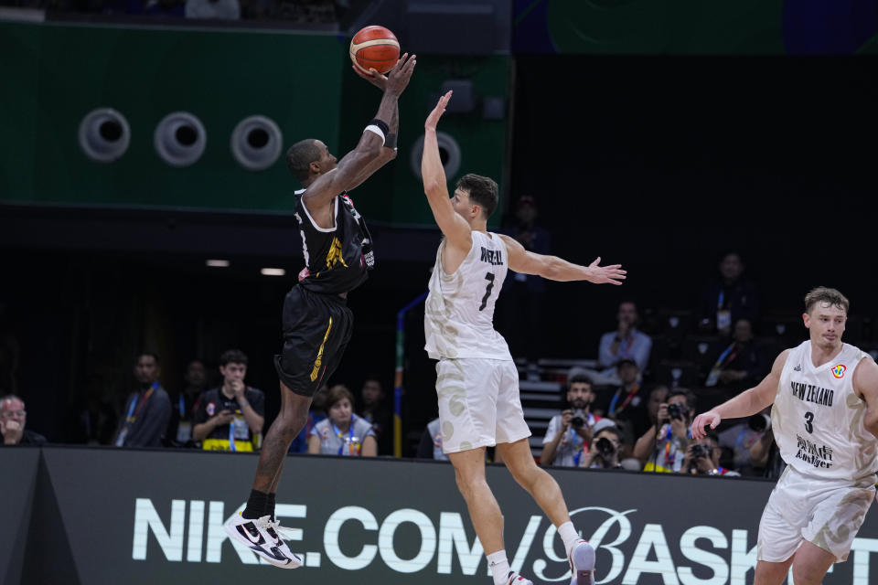 Jordan forward Rondae Hollis Jefferson (24) is fouled as he hits a three-point basket over New Zealand forward Yannick Wetzell (7) in the closing second of the fourth quarter during a Basketball World Cup group C match in Manila, Philippines Monday, Aug. 28, 2023. New Zealand defeated Jordan 95-87. (AP Photo/Michael Conroy)