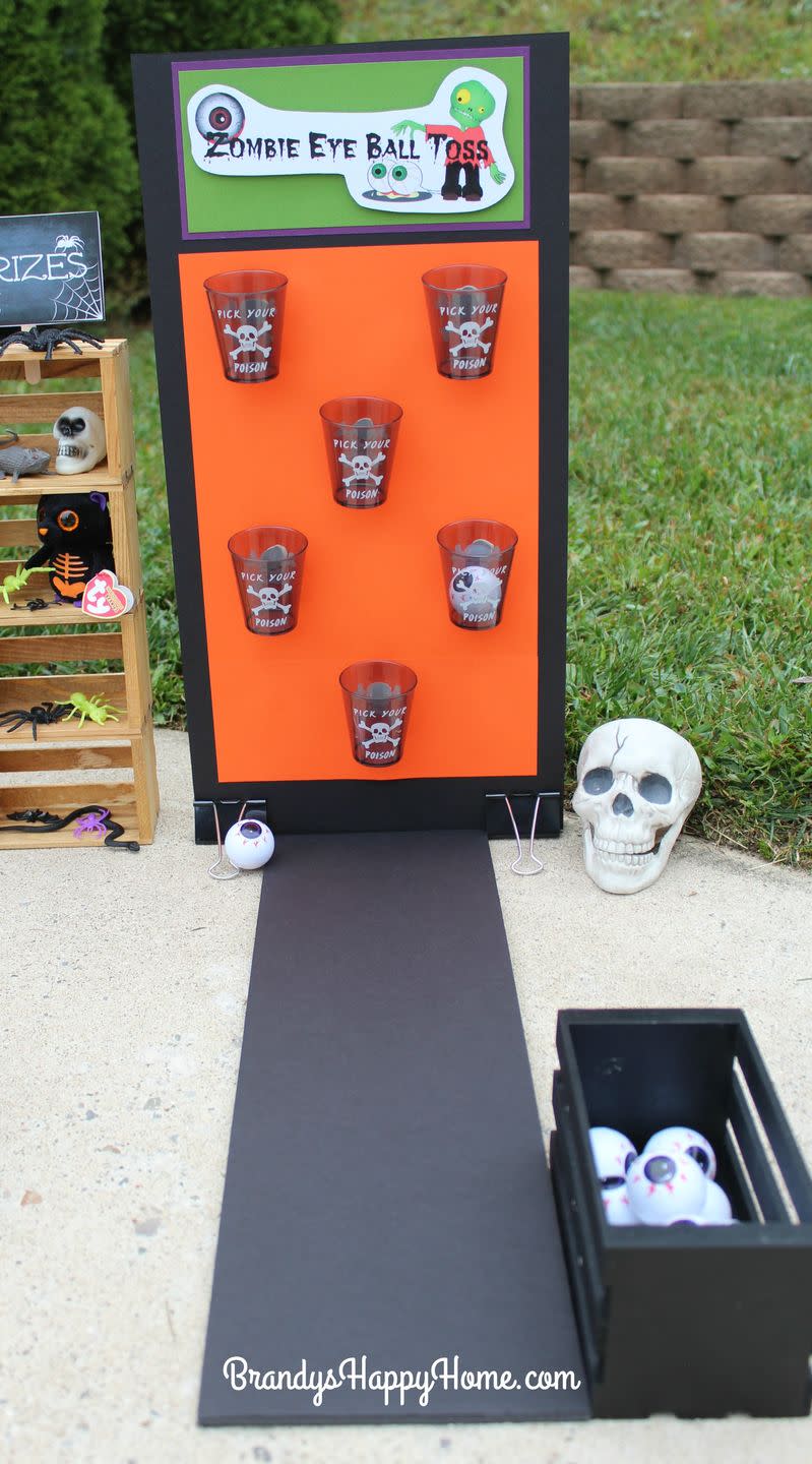 <p>Stock up on spooky Halloween cups at your local convenience store, then scatter them on a poster board for kids to take aim—with zombie eyeballs, of course. </p><p><strong>Get the tutorial at <a href="http://brandyshappyhome.com/dolloween-carnival-part-2-carnival-games/" rel="nofollow noopener" target="_blank" data-ylk="slk:Brandy's Happy Home;elm:context_link;itc:0;sec:content-canvas" class="link ">Brandy's Happy Home</a>. </strong></p><p><strong><a class="link " href="https://www.amazon.com/Metallic-Poison-Plastic-Tumblers-30ct/dp/B07D7HNKFG/?tag=syn-yahoo-20&ascsubtag=%5Bartid%7C10050.g.3476%5Bsrc%7Cyahoo-us" rel="nofollow noopener" target="_blank" data-ylk="slk:SHOP CUPS;elm:context_link;itc:0;sec:content-canvas">SHOP CUPS</a><br></strong></p>