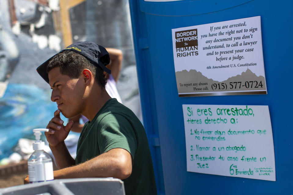 Colombian migrant Shristian Villa, 19, waits for food from the Sacred Heart Church shelter in El Paso, Texas, Friday, May 12, 2023. The border between the U.S. and Mexico was relatively calm Friday, offering few signs of the chaos that had been feared following a rush by worried migrants to enter the U.S. before the end of pandemic-related immigration restrictions. (AP Photo/Andres Leighton)