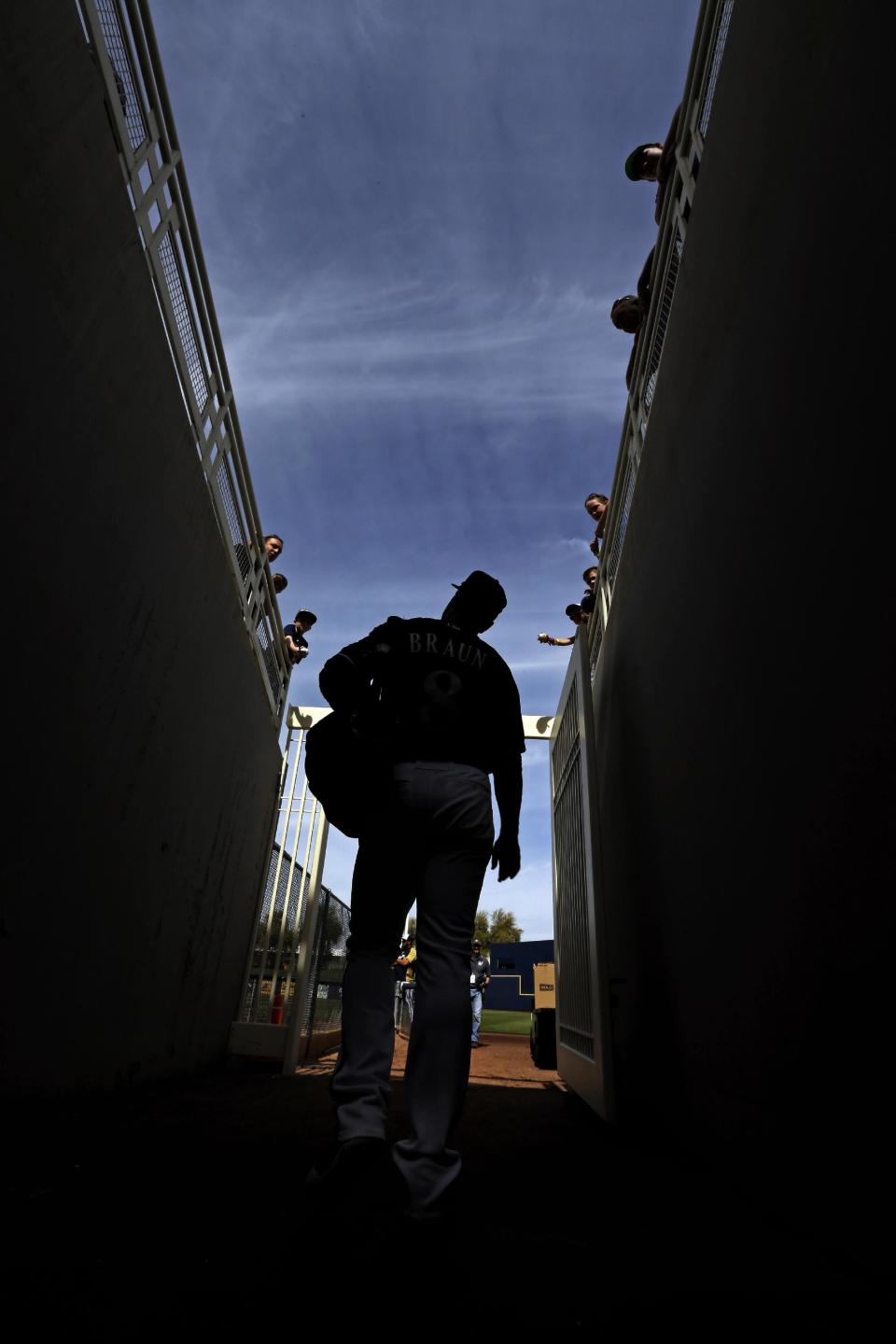 Milwaukee Brewers' Ryan Braun makes his way to an exhibition spring training baseball game against the Oakland Athletics Wednesday, March 5, 2014, in Phoenix. (AP Photo/Morry Gash)