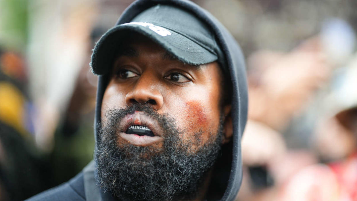 PARIS, FRANCE - OCTOBER 02: Kanye West aka Ye is seen wearing a Balenciaga boxing mouthguard, outside Givenchy, during Paris Fashion Week - Womenswear Spring/Summer 2023 - Day Seven on October 02, 2022 in Paris, France. (Photo by Edward Berthelot/GC Images)