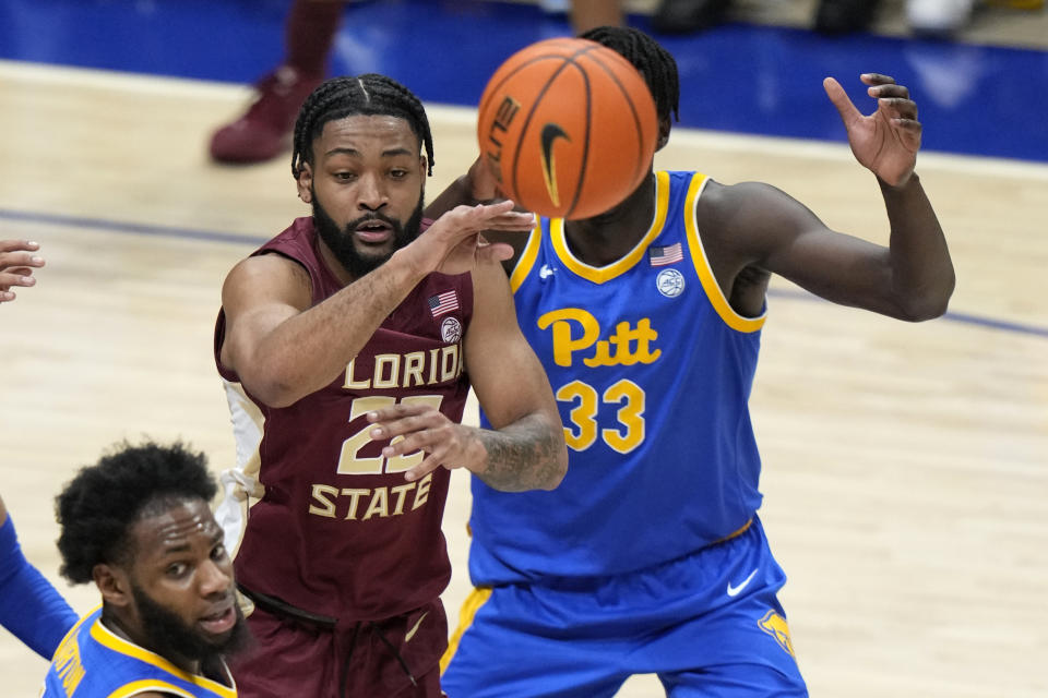 Florida State guard Darin Green Jr. (22) gets off a pass with Pittsburgh center Federiko Federiko (33) defending during the second half of an NCAA college basketball game in Pittsburgh, Saturday, Jan. 21, 2023. Florida State won 71-64. (AP Photo/Gene J. Puskar)