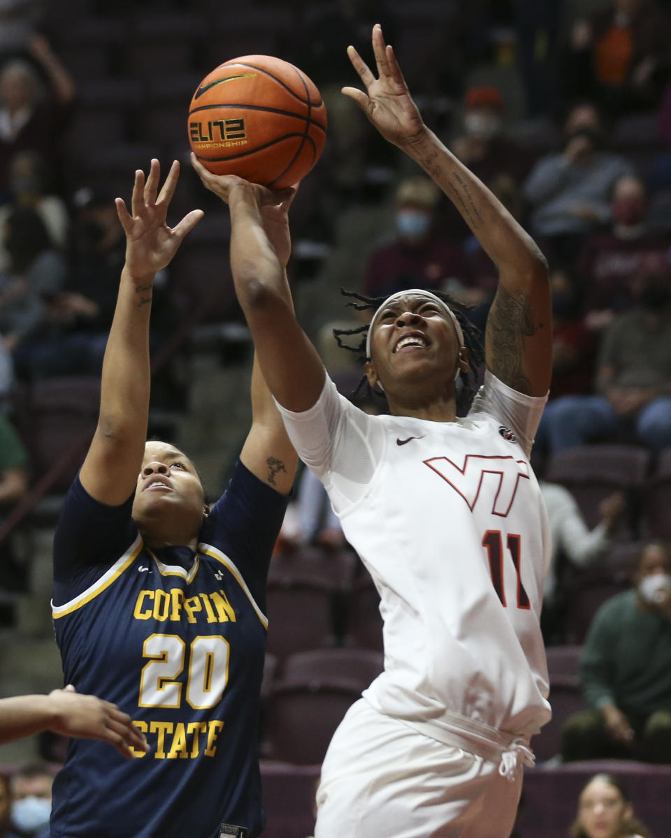 Virginia Tech's D'asia Gregg (11) shoots past Coppin State's Jaia Alexander (20) during in the first half of an NCAA college basketball game in Blacksburg Va., Wednesday, Nov. 17 2021. (Matt Gentry/The Roanoke Times via AP)