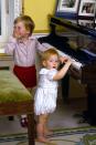 <p>Prince Harry plays piano with his brother, Prince William, during a photo session at Kensington Palace. </p>