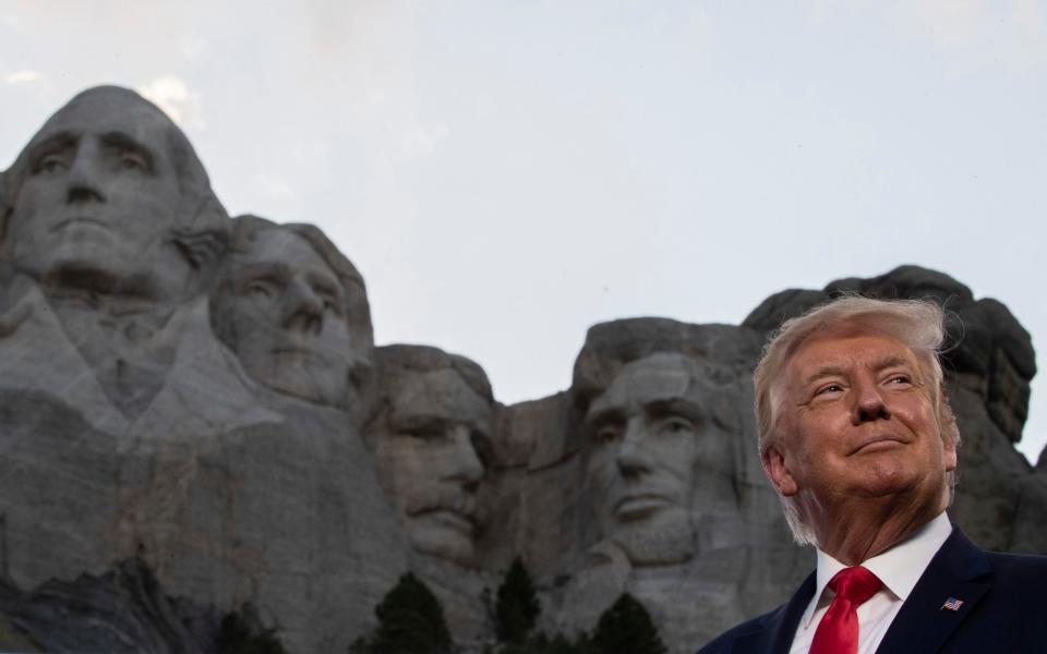 President Donald Trump smiles during a visit to Mount Rushmore - AP Photo/Alex Brandon