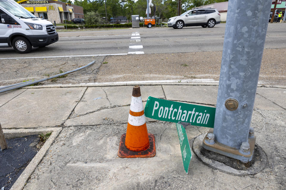 A damaged traffic light and street sign at the intersection of Pontchartrain Drive and Kostmayer Avenue in Slidell, La., the day after a tornado swept through parts of Slidell, La., on Thursday, April 11, 2024. (Chris Granger/The Times-Picayune/The New Orleans Advocate via AP)