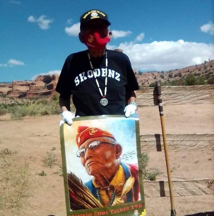 John Kinsel holds a poster depicting Navajo Code Talkers. The image was also put on a Navajo Code Talker event t-shirt in 2018.