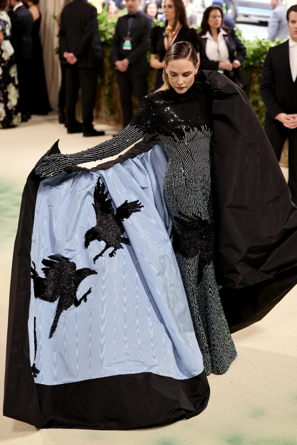 Rebecca Ferguson showing off the inside of her cape, which features two ravens