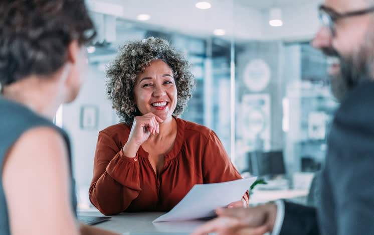 A financial advisor walking new clients through a financial plan.