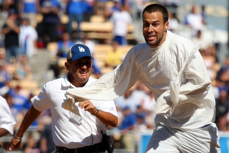 A fan is chased by security after running onto the field in the sixth inning during the game between the Arizona Diamondbacks and the Los Angeles Dodgers at Dodger Stadium September 16, 2007 in Los Angeles, California. (Photo by Lisa Blumenfeld/Getty Images)