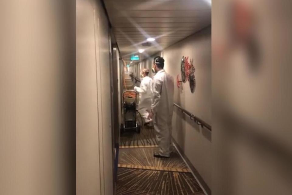 Crew members were filmed hosing down the hallways of the luxury liner on Monday: Facebook