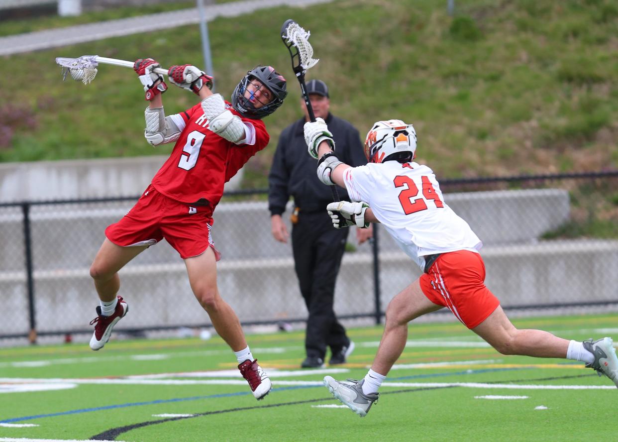 Rye's Tucker Hess (9) fires a shot in front of Mamaroneck's Teddy Auker (24) during boys lacrosse action at Mamaroneck High School April 5, 2023. Rye won the game 13-10.