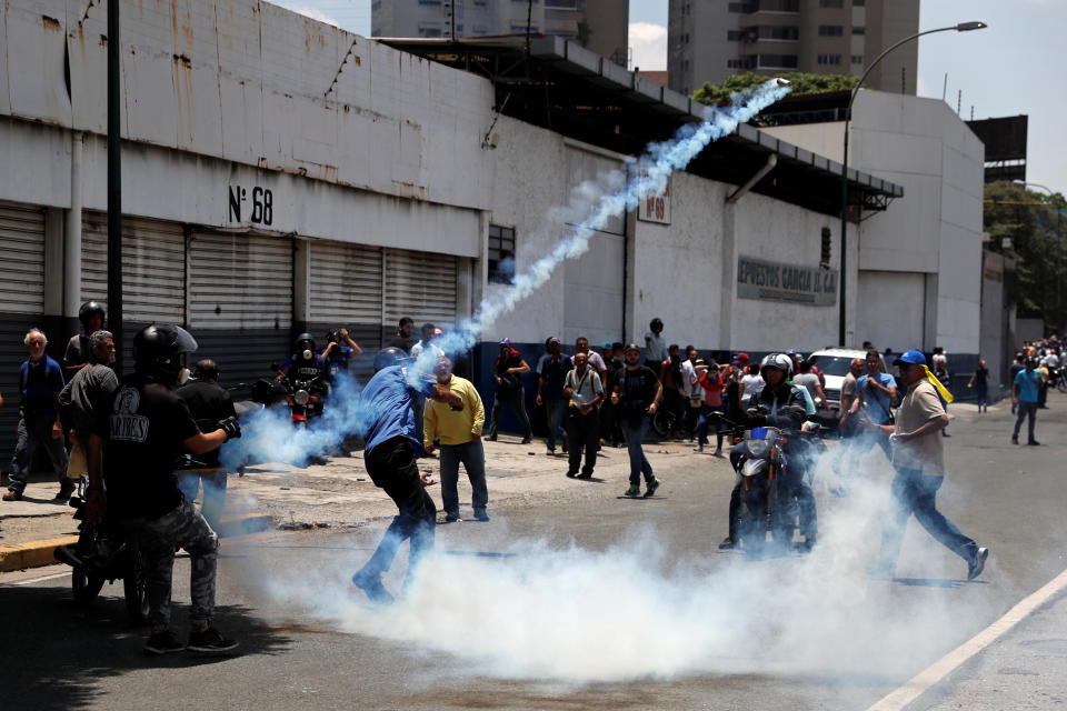 Opposition demonstrators clash with security forces near the Generalisimo Francisco de Miranda Airbase “La Carlota” in Caracas