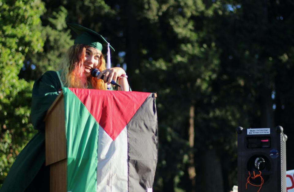 University of Oregon graduating senior Rocky Stern address her peers during a commencement ceremony on Friday hosted by students and others involved in the pro-Palestinian encampment organized on campus this spring.
