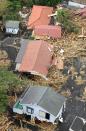 An aerial view shows collapsed houses following a landslide caused by Typhoon Wipha on Izu Oshima island, south of Tokyo, in this photo taken by Kyodo October 16, 2013. Four people were reported killed, schools closed, hundreds of flights cancelled and thousands were advised to evacuate as Typhoon Wipha pummelled Tokyo on Wednesday, although the Japanese capital escaped major damage. Mandatory Credit. (REUTERS/Kyodo)