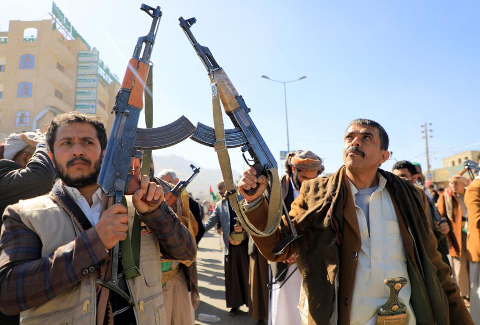Houthi fighters brandish their weapons during a march in solidarity with the Palestinian people in the Huthi-controlled capital Sanaa on January 11, 2024, amid the ongoing battles between Israel and the militant Hamas group in Gaza. Heavy air strikes pounded rebel-held cities in Yemen early on January 12, 2024, the Huthi rebels' official media and AFP correspondents said. The capital Sanaa, Hodeida and Saada were all targeted, the Huthis' official media said, blaming "American aggression with British participation".