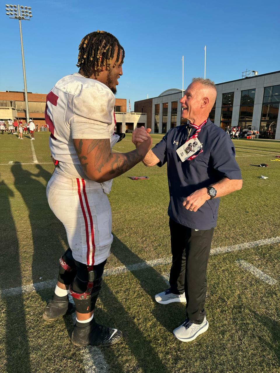 Alabama tackle JC Latham reunites with his high school coach, Bill Young of Catholic Memorial, during a 2023 spring practice.
