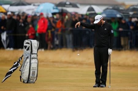 Golf - The 147th Open Championship - Carnoustie, Britain - July 20, 2018 Dustin Johnson of the U.S. takes a drop on the 18th during the second round REUTERS/Andrew Yates