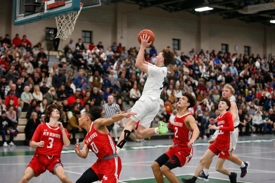 Dartmouth's Aiden Smith goes up for the layup. Dartmouth High School boys basketball team beat New Bedford High School at home.