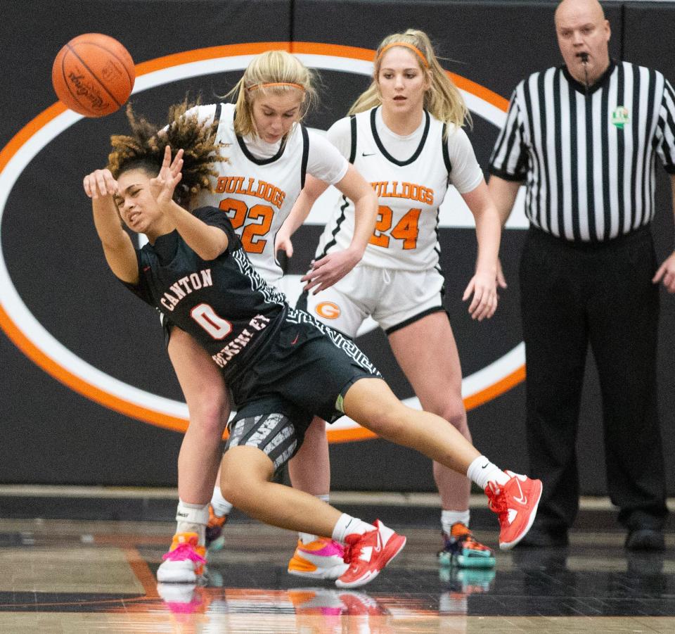 McKinley's Mya Taylor fires off a rebound in the second half with pressure from Green's Nina Shaffer, left, and Jenna Slates at Green.