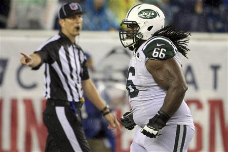 New York Jets Willie Colon runs off the field after being ejected for fouling an official in the fourth quarter against the New England Patriots during their NFL AFC East football game in Foxborough, Massachusetts, September 12, 2013. REUTERS/Dominick Reuter