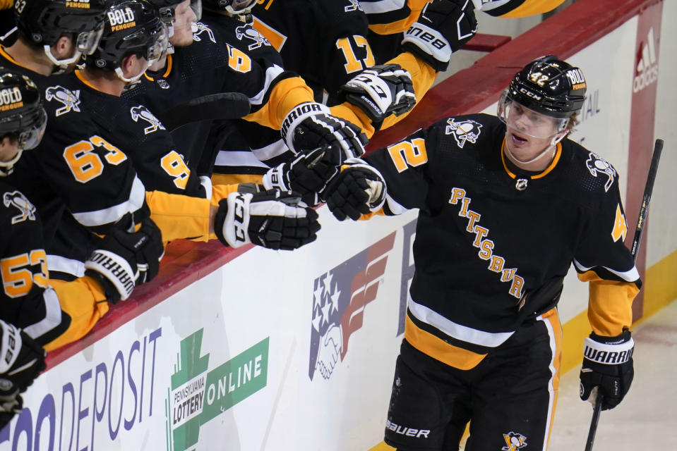 Pittsburgh Penguins' Kasperi Kapanen (42) returns to the bench after scoring during the first period of an NHL hockey game against the Detroit Red Wings in Pittsburgh, Sunday, March 27, 2022. (AP Photo/Gene J. Puskar)