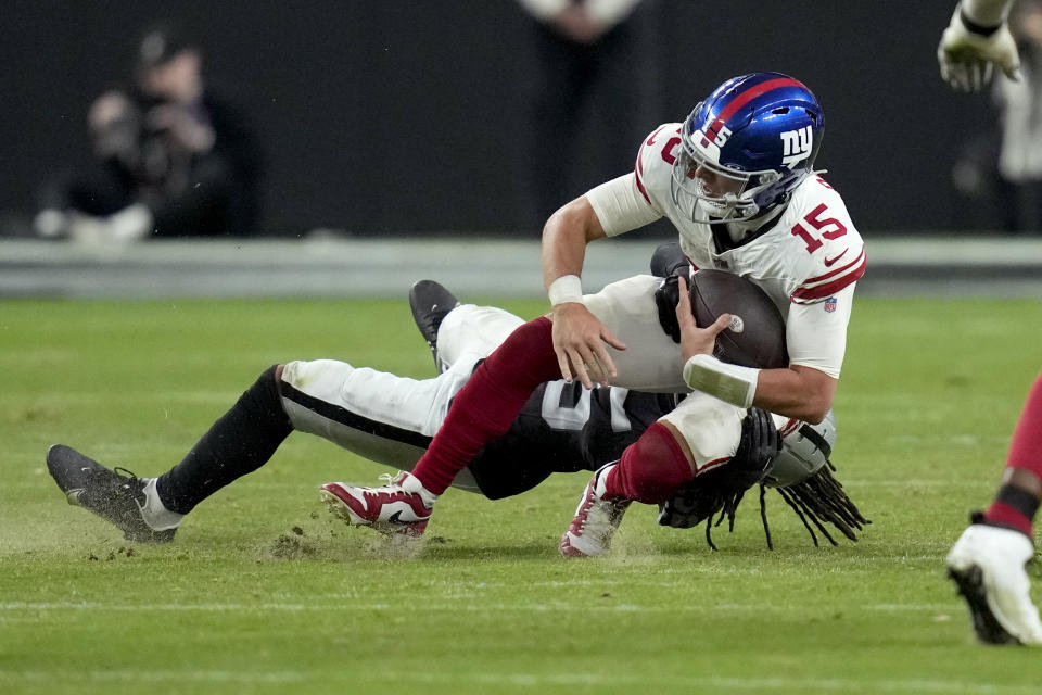 Las Vegas Raiders safety Tre'von Moehrig (25) sacks New York Giants quarterback Tommy DeVito (15) during the second half of an NFL football game, Sunday, Nov. 5, 2023, in Las Vegas. (AP Photo/John Locher)