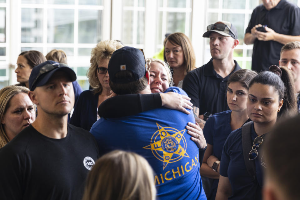 Family and friends of Christopher Schurr exit Kent County District Court as Grand Rapids Police officer Schurr appeared on video from jail, Friday, June 10, 2022 in Grand Rapids, Mich. A judge facing a packed courtroom set bond Friday at $100,000 for Schurr, a Michigan police officer charged with second-degree murder in the death of Patrick Lyoya, a Black man who was shot in the back of the head in April. (Joel Bissell/The Grand Rapids Press via AP)