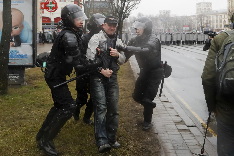 Belarus police detain an activist during an opposition rally in Minsk, Belarus, Saturday, March 25, 2017. A cordon of club-wielding police blocked the demonstrators' movement along Minsk's main avenue near the Academy of Science. Hulking police detention trucks were deployed in the city center. (AP Photo/Sergei Grits)