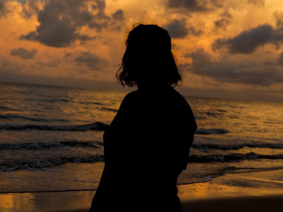 woman sunset beach