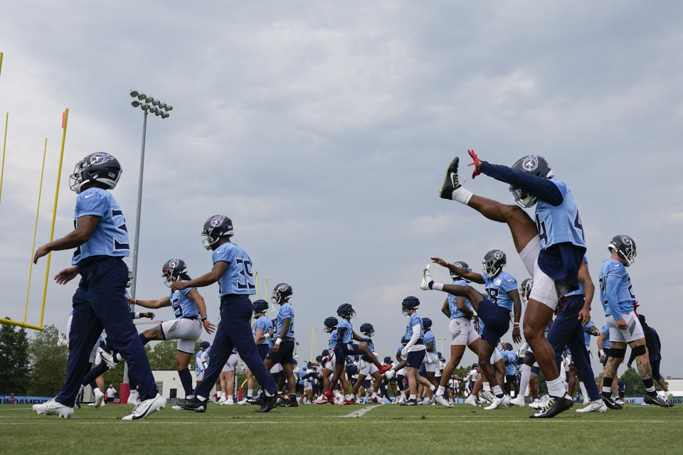 Tennessee Titans warm up for an NFL football training camp practice Wednesday, July 26, 2023, in Nashville, Tenn. (AP Photo/George Walker IV)