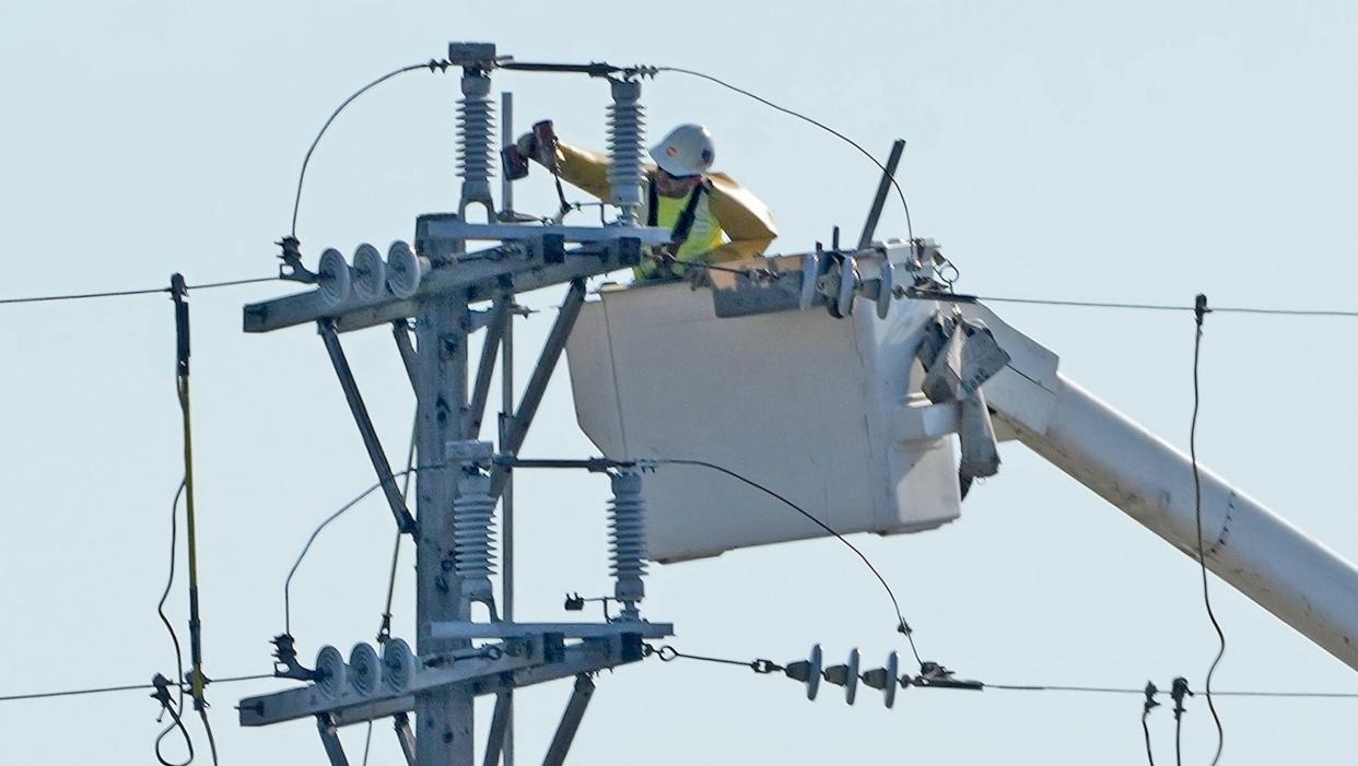 Crews with WE Energies perform maintenance work on electric lines off of North Port Washington Road south of West Henry Clay Street in Glendale, on Sunday, Oct. 23, 2022.