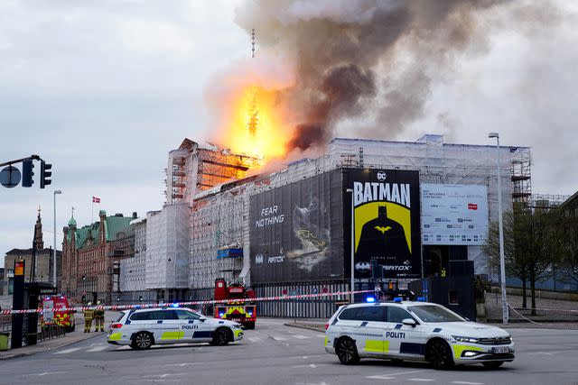 <p>IDA MARIE ODGAARD/Ritzau Scanpix/AFP via Getty Images</p> Police cars park as flames engulf the Copenhagen's Stock Exchange building on April 16, 2024
