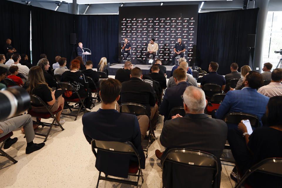 Cleveland Cavaliers guard Donovan Mitchell, center, president of basketball operations Koby Altman, left, and head coach J.B. Bickerstaff sit on stage during an NBA basketball news conference, Wednesday, Sept. 14, 2022, in Cleveland. (AP Photo/Ron Schwane)