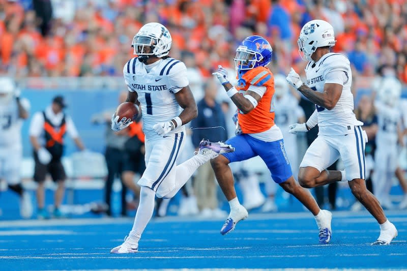 Utah State wide receiver Jalen Royals (1) runs past the Boise State defense on a 75-yard touchdown reception in the first half of an NCAA college football game, Saturday, Oct. 5, 2024, in Boise, Idaho. . (AP Photo/Steve Conner) | Steve Conner