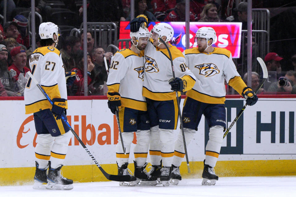 Nashville Predators center Thomas Novak, second from left, is congratulated by teammates after he scored against the Washington Capitals during the first period of an NHL hockey game Friday, Jan. 6, 2023, in Washington. (AP Photo/Jess Rapfogel)