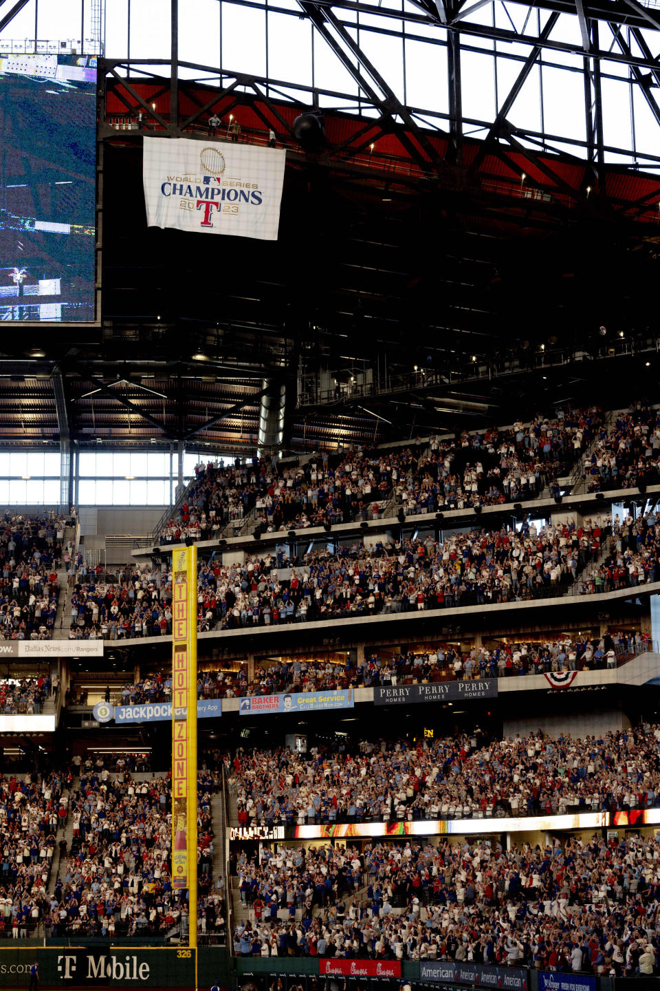 The Texas Rangers unveil their 2023 World Series champions banner before a baseball game against the Chicago Cubs, Thursday, March 28, 2024 in Arlington, Texas. (AP Photo/Gareth Patterson)