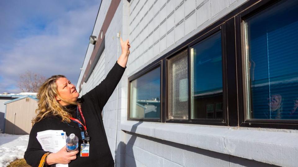 Boundary County School District Superintendent Jan Bayer points out that part of an exterior wall of a school building is made of glass blocks painted blue, which are not efficient for heating and cooling. The rest of the building is made of cinder blocks that came from a naval training station that was decommissioned in the 1940s.